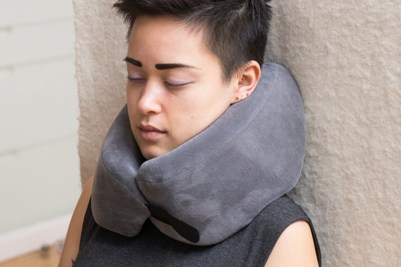 Woman wearing the Travelrest Ultimate Memory Foam Travel Pillow.